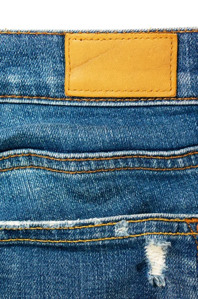 Closeup blue jeans with leather label — Stock Photo, Image