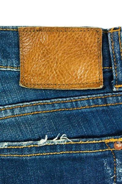 Mavi jeans ile beyaz deri etiket — Stok fotoğraf
