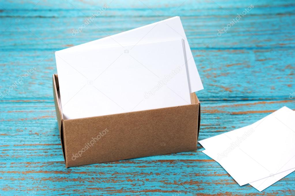 Business cards in paper box on wood desk