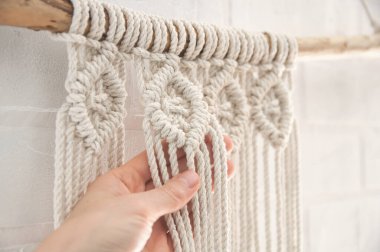 Ev yapımı için makrome tekniği ve prodüksiyon sürecinde düğün dekoru kullanılarak doğal renk pamuk ipliklerinden yapılmış boho duvar resmi