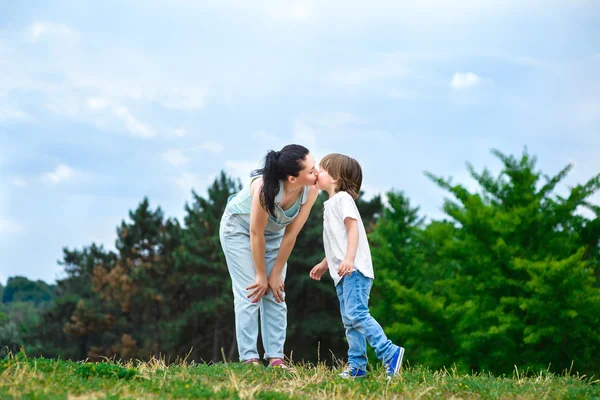 Loving son kissing his happy mother on the cheek