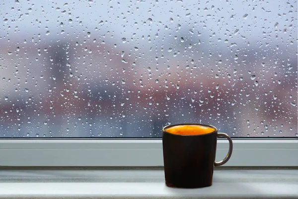 Front view window sill on falling rain drops