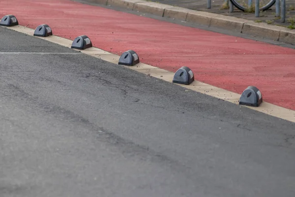 Safety in road traffic for bicycles and bikers by bike way protection and car guidance systems on the red lane for cyclists shows biking friendly city streets for sustainable mobility and ecology