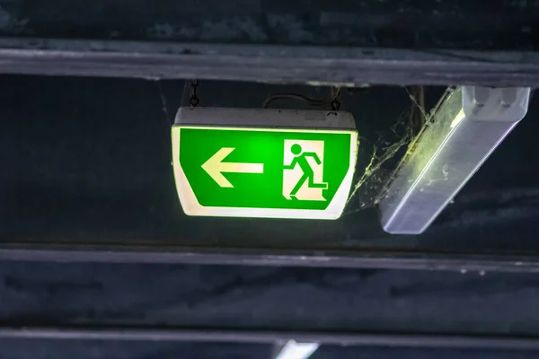 Green Exit Sign Running Person Green Arrow Shows Guidance System — Stock Photo, Image