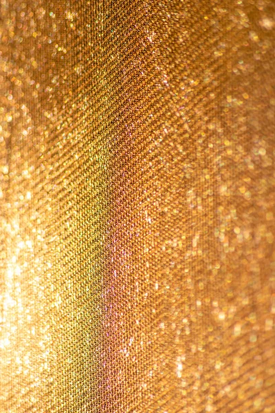 Yellow mesh structure in close-up with backlight on shine morning shows abstract pattern of seamless material textured in golden light as graphical element for backdrop wallpaper and fabric macro