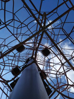 High rope climbing frame on a playground in summer to encourage children to climb and train physical strength by challenging with fear of heights and vertigo as adventure activity for balance and joy
