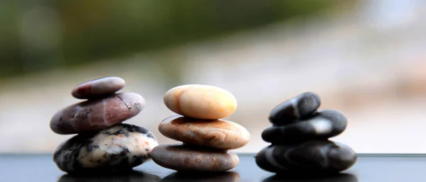 Sea stones. Pyramids of small stones. Sea background.