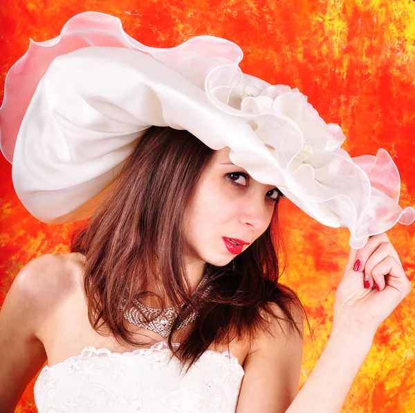 Young girl in a wedding dress and hat — Stock Photo, Image