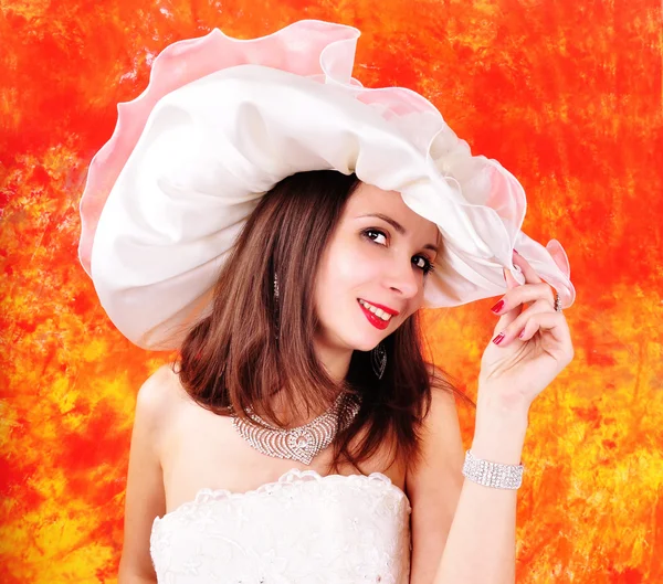 Young girl in a wedding dress and hat — Stock Photo, Image