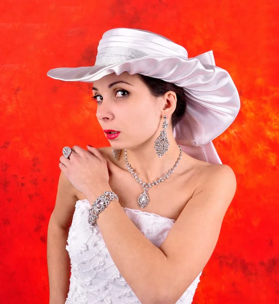 Young girl in a wedding dress and hat — Stock Photo, Image