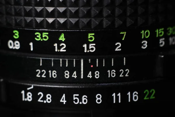 Macro close-up of a photographic lens with focus rings and diaphragm. Lens for photography, video and cinema