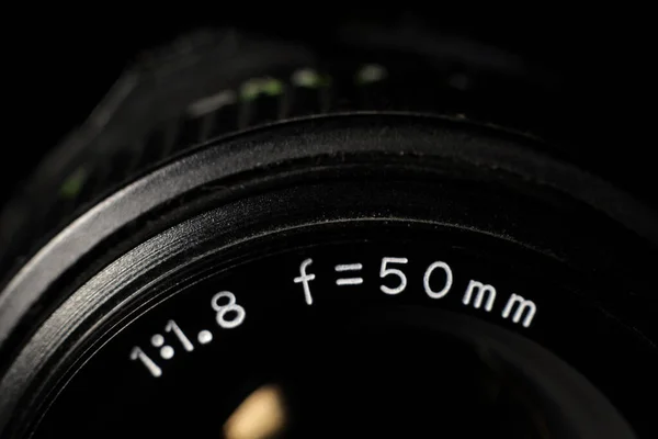 Macro close-up of a photographic lens with focus rings and diaphragm. Lens for photography, video and cinema