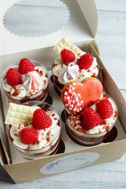 Sevgililer Günü 'nde aşıklar için tatlı. Ahududu reçelli kırmızı bisküvi, krema ve taze ahududu..