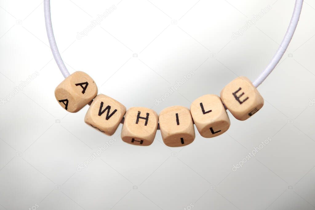 Word accustom lined with wooden cubes