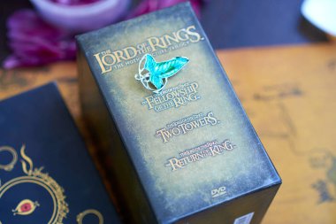 Astrakhan, Russia - 05.12.2021: Elven Lorien brooch lies on Lord of the Rings Trilogy Special Extended Edition 12-DVD Box Set