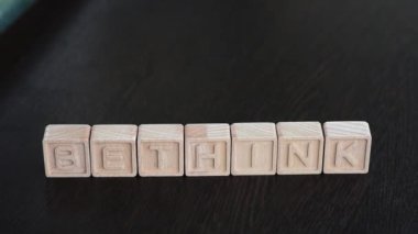 Female hands change first letter in word bethink so that it turns to rethink. Concept