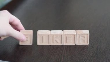 Female hands change first letter in word biker so that it turns to hiker. Concept
