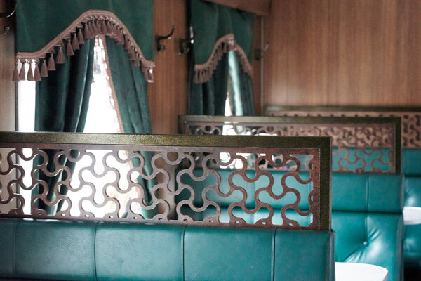 The interior of a steam-powered tourist retro train, stylized as Nikolaevskii Express and going along the route of Sortavala Ruskeala