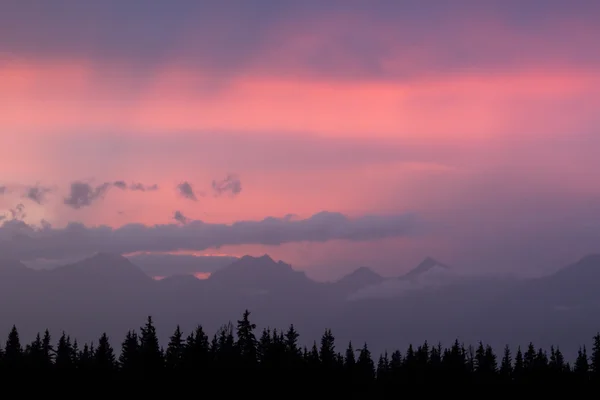 Bulutlar dağlarda karşı günbatımı — Stok fotoğraf