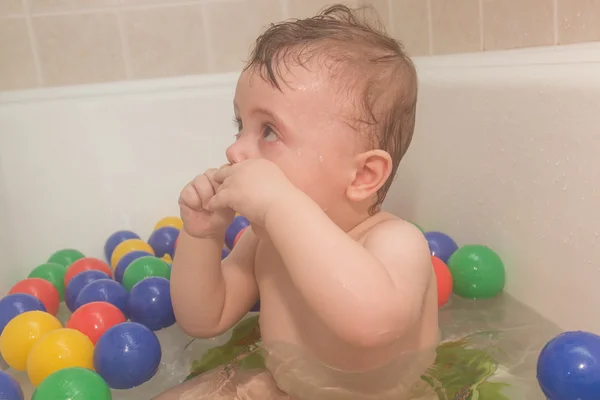 O bebê no banheiro com bolas coloridas . — Fotografia de Stock