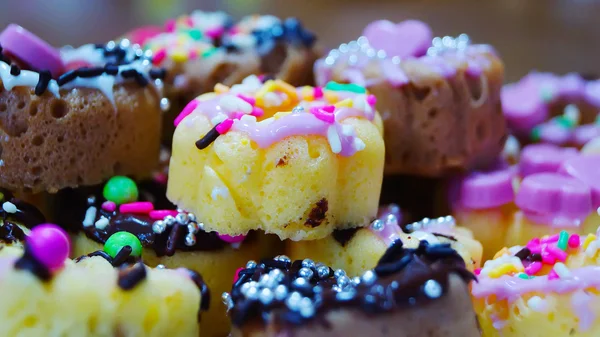Красочные и вкусные мини пончики на белом фоне — стоковое фото