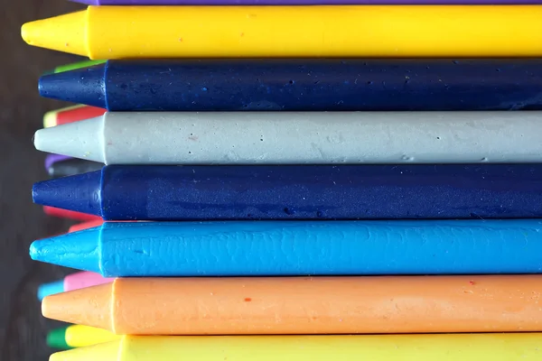 Coloridos crayones pastel de aceite sobre una mesa negra de madera —  Fotos de Stock