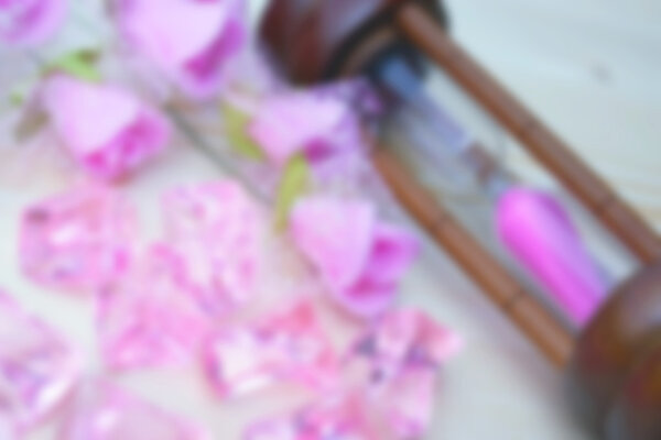 pink plastic rose with  sandglass blure background