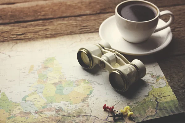 travel items -binocular, map, coffee, camera and phone