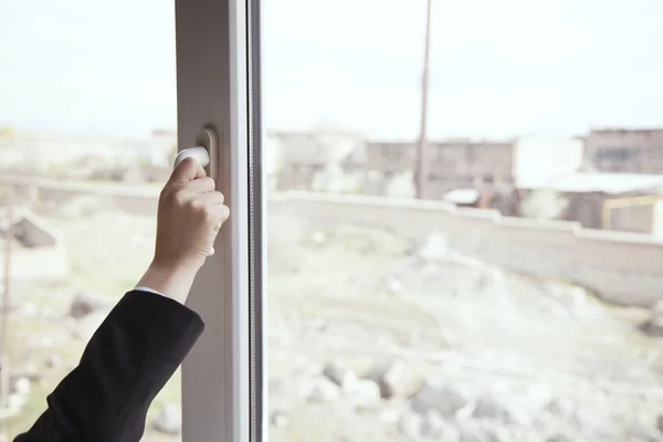 Woman opens a window — Stock Photo, Image