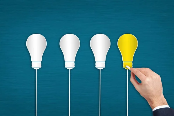 Creative design of light bulb on man hand