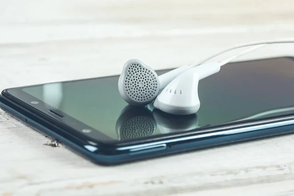 earphone on phone on desk