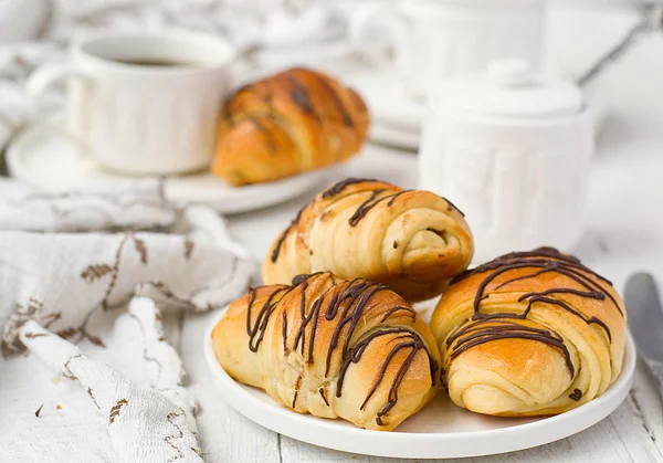 Puff pastry rolls with chocolate and coffee cup — Stock Photo, Image