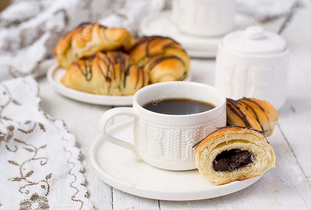 Puff pastry rolls with chocolate and coffee cup