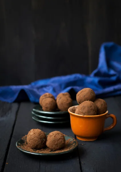 Candy with dates, chocolate and coconut on a dark background — Stock Photo, Image