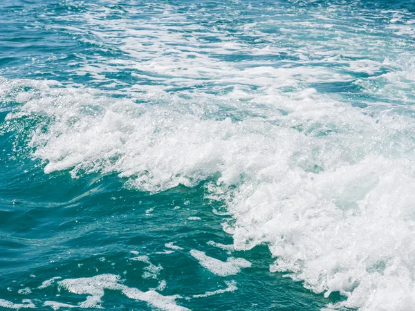 Artificial sea waves created by motor boat Stock Picture