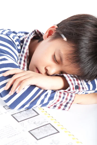 A young boy doing homework on a white background. — Stok fotoğraf