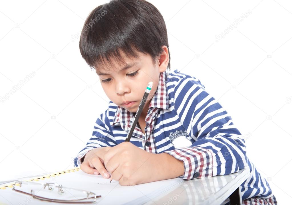 A young boy doing homework on a white background.