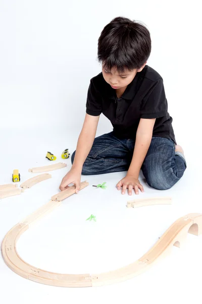 Boy building with colorful wooden blocks — Stock Photo, Image