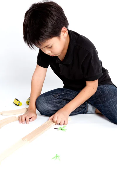 Boy building with colorful wooden blocks — Stock Photo, Image