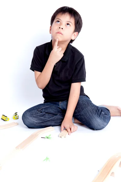 Boy building with colorful wooden blocks — Stock Photo, Image