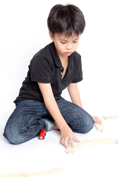 Boy building with colorful wooden blocks — Stock Photo, Image