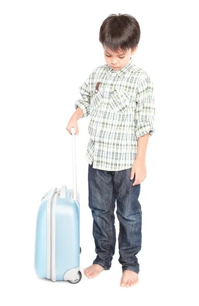 Мальчик с чемоданом стоит — стоковое фото