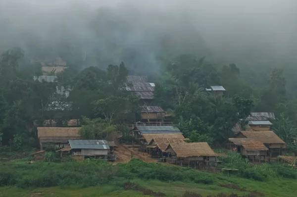 Old wooden small village in misty foggy morning — Stock Photo, Image