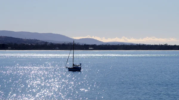 Little sailboat in a calm lake — Stock Photo, Image