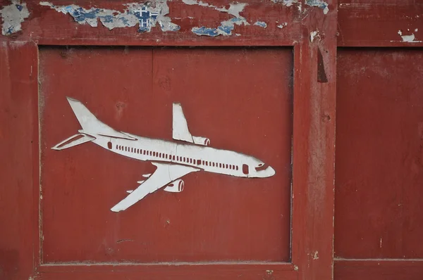 Aeroplane carved on old wooden door pane — Stock Photo, Image