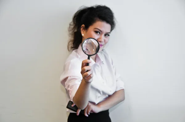 Business woman hold magnifier and a mobile phone — Stock Photo, Image