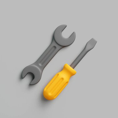 Gri yüzeyde yan yana duran sarı saplı 3 boyutlu anahtar ve tornavida.