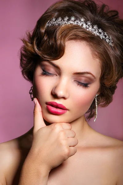 Retrato de novia hermosa. Vestido de novia. Decoración de la boda. Retrato de una hermosa mujer en la imagen de la novia con una joya en el pelo. Foto tomada en el estudio sobre fondo rosa . —  Fotos de Stock