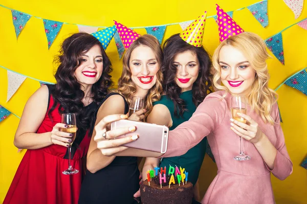 Best friends taking selfie .Portrait of joyful friends toasting and looking at camera at birthday party. Attractive friends celebrating a birthday. Smiling girls with glasses of champagne Stock Image