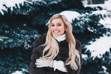 Kış karlı ormanında gülümseyen kadın. Kış tatili kavramı